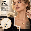 CHANEL Gold-Tone CC Pendant Necklace with Blue Accent