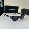 CHANEL Black Oval Sunglasses with Gold-Tone Accents