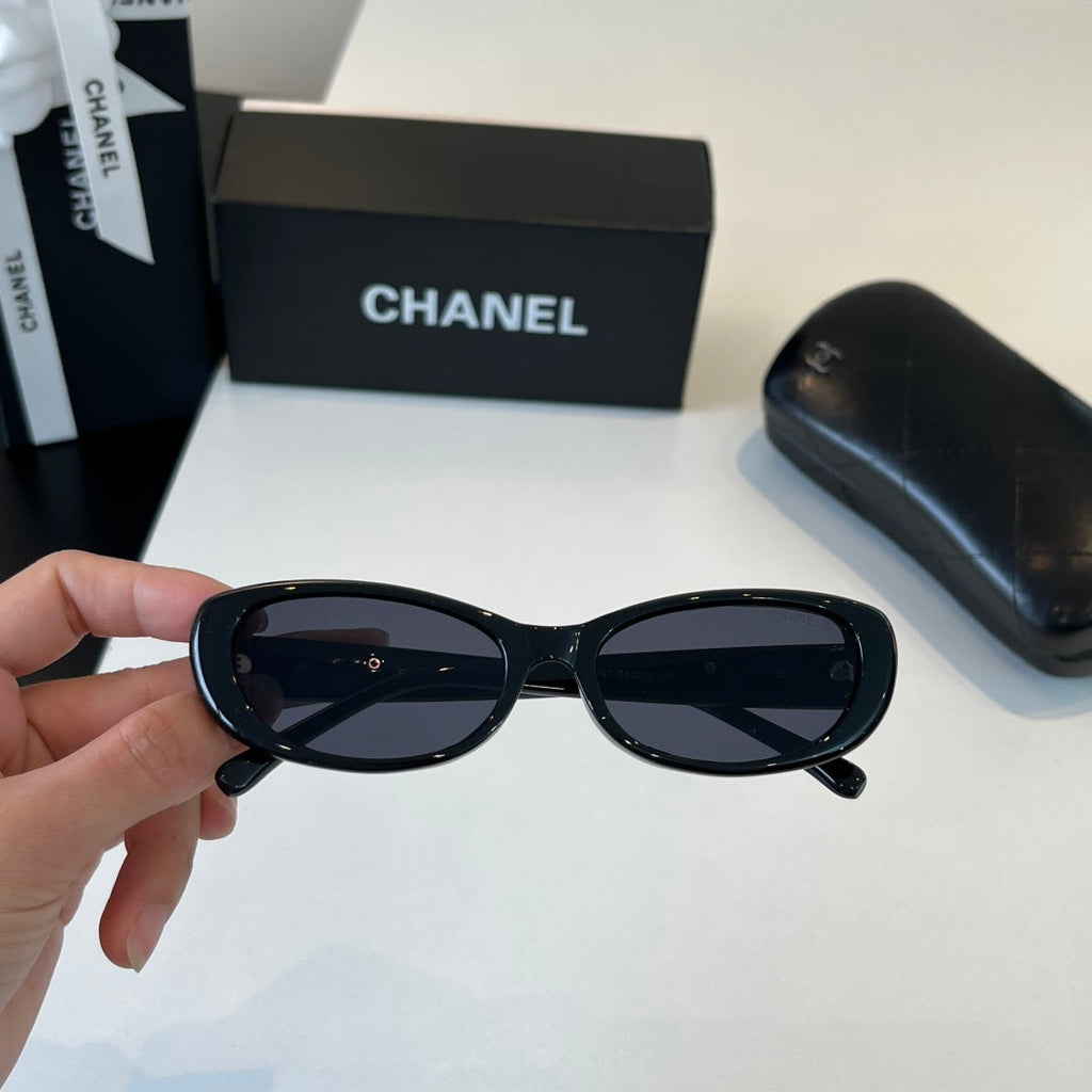 CHANEL Black Oval Sunglasses with Gold-Tone Accents