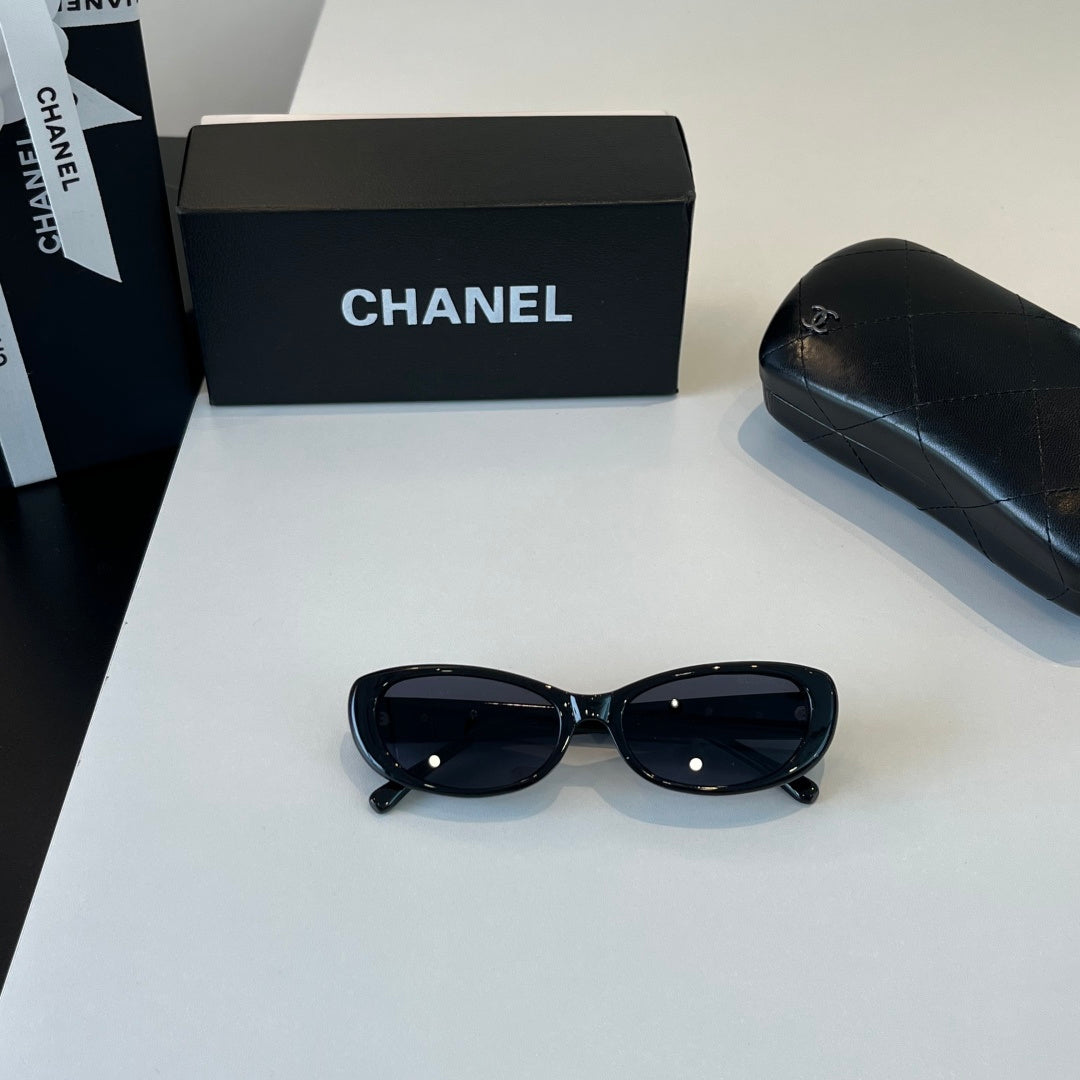 CHANEL Black Oval Sunglasses with Gold-Tone Accents
