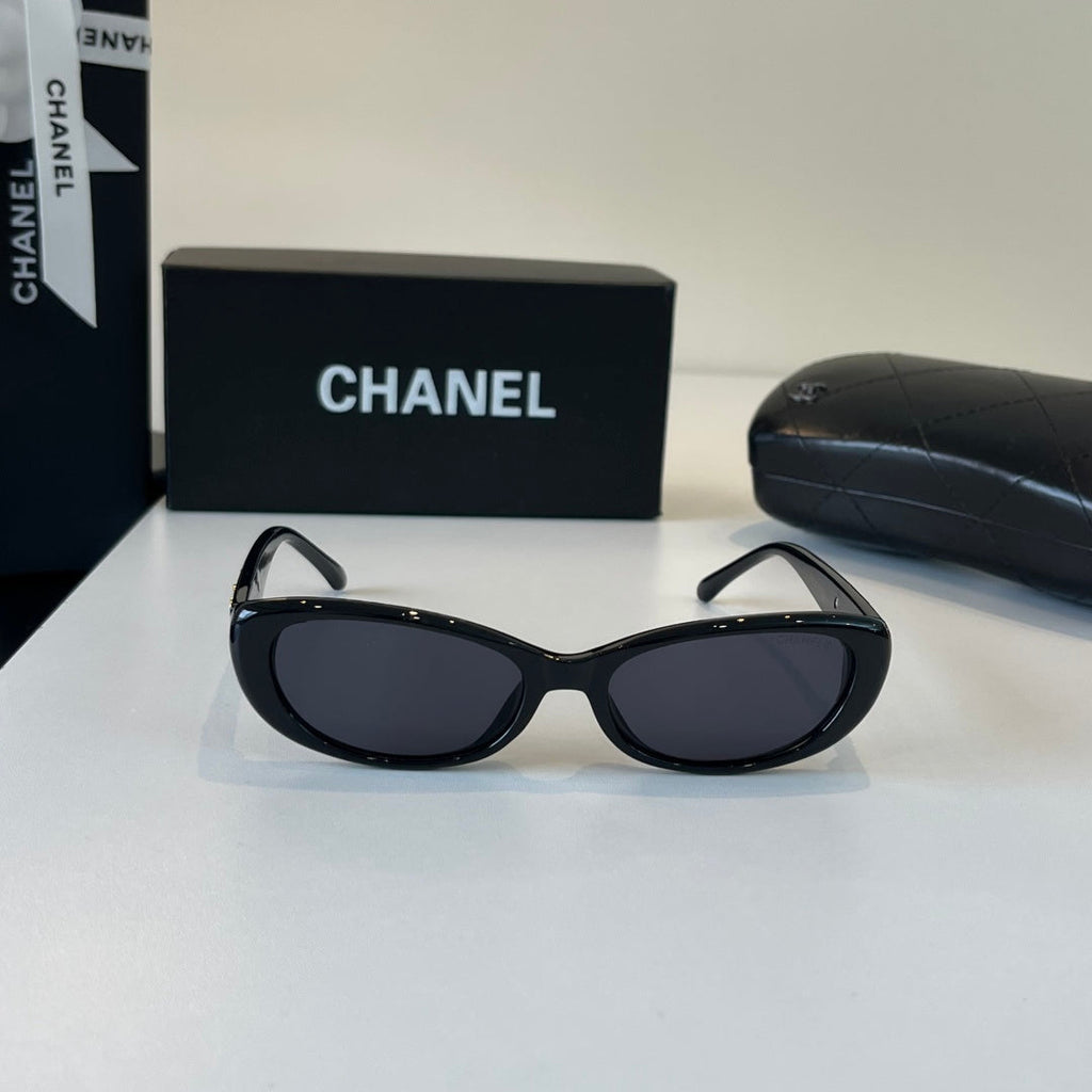 CHANEL Black Oval Sunglasses with Gold-Tone Accents