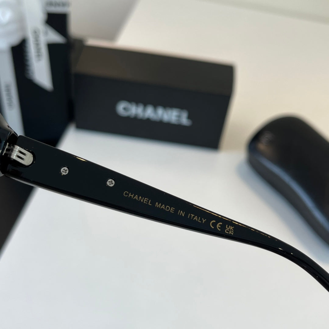 CHANEL Black Oval Sunglasses with Gold-Tone Accents