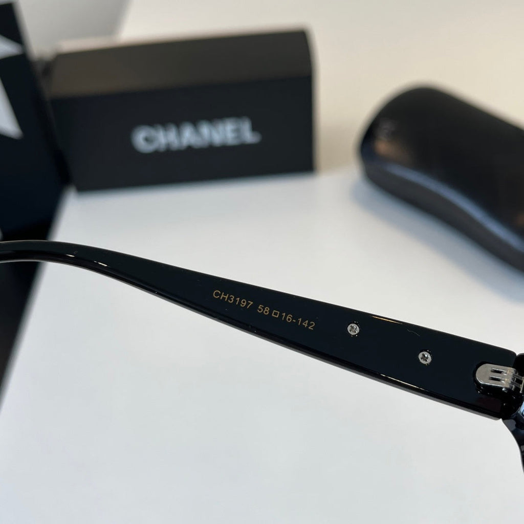 CHANEL Black Oval Sunglasses with Gold-Tone Accents