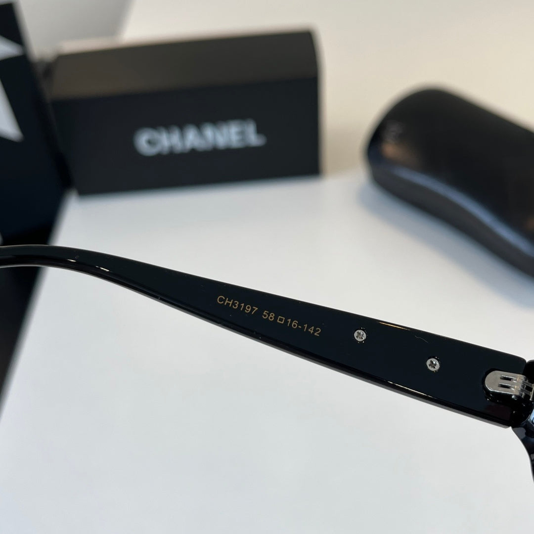CHANEL Black Oval Sunglasses with Gold-Tone Accents